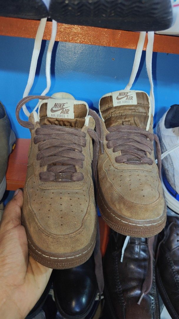 Nike Air Force 1 Brown Suede (Category: Sneakers) located in San Francisco. Submitted by Intaw20 (Listing ID 1469322902, Image 3). Description: - Brand/Model: Nike Air Force 1 - Material: Premium brown suede upper - Details: Thick matching brown laces, speckled rubber sole - Branding: White embroidered Nike Air logo on heel and tongue tag - Condition: Clean uppers with minimal wear on the bottom tread.