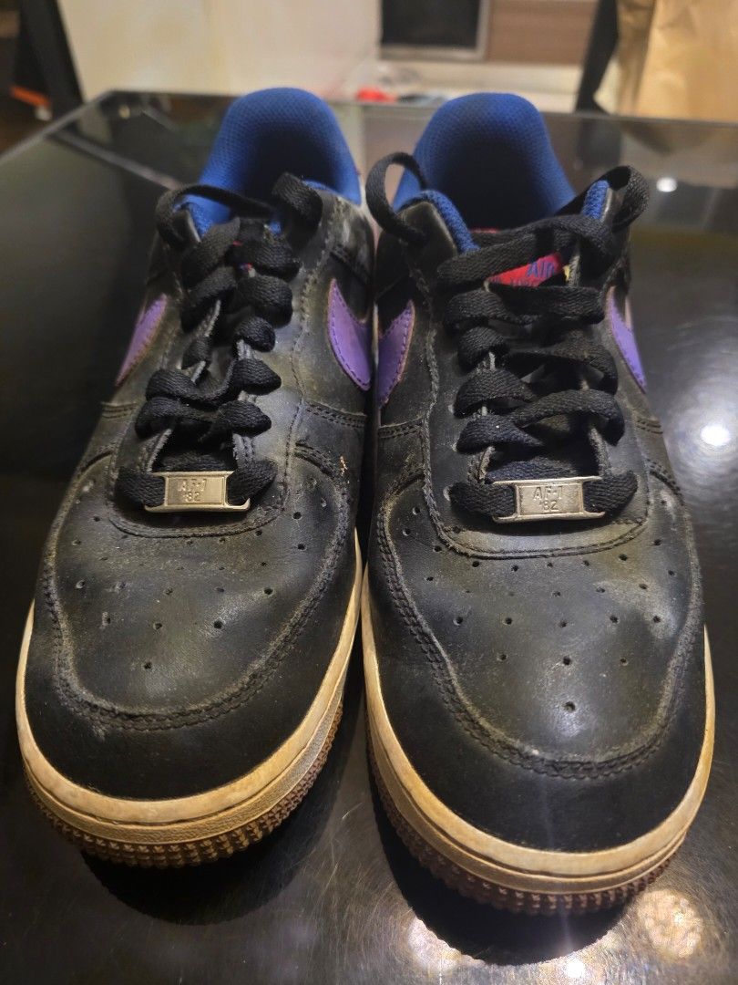 Nike Air Force 1 Low City Edition (Category: Sneakers) located in Manila. Submitted by collectndeclutt (Listing ID 1469302764, Image 2). Description: - Brand: Nike Air Force 1 - Color/Material: Black leather upper with purple side swoosh - Accents: Blue inner lining, bright red heel tabs, and blue embroidered Nike Air branding - Special Detail: Embroidered NYC city skyline graphic with NYC lettering on the lateral heel - Condition: White midsoles