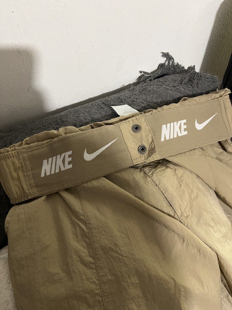 Nike Beige Nylon Cargo Pants Size L (Category: Joggers) located in Manila. Submitted by mazerunnr (Listing ID 1469307052, Image 3). Description: - Brand: Nike - Item: Cargo Pants - Color: Beige - Size: L - Material: 100% Nylon (Body & Lining) - Fit: Relaxed utility fit - Features: Elastic waistband with printed Nike logo, snap button closure, side cargo pockets - Condition: Almost Brand new / Excellent quality.