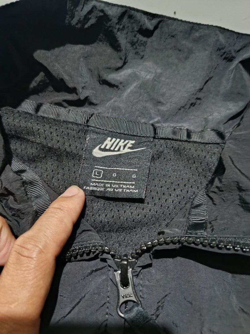 Nike Big Swoosh Black White Windbreaker Jacket (Category: Coats, Jackets and Outerwear) located in Barotac Nuevo. Submitted by gray101 (Listing ID 1469291324, Image 3). Description: - Brand: Nike - Style: Black and white windbreaker with large wrap-around Swoosh design - Size: Large (tag attached) - Material: Durable nylon body with breathable mesh lining - Hardware: Smooth full-zip closure with YKK zippers - Origin: Made in Vietnam - Condition: 
