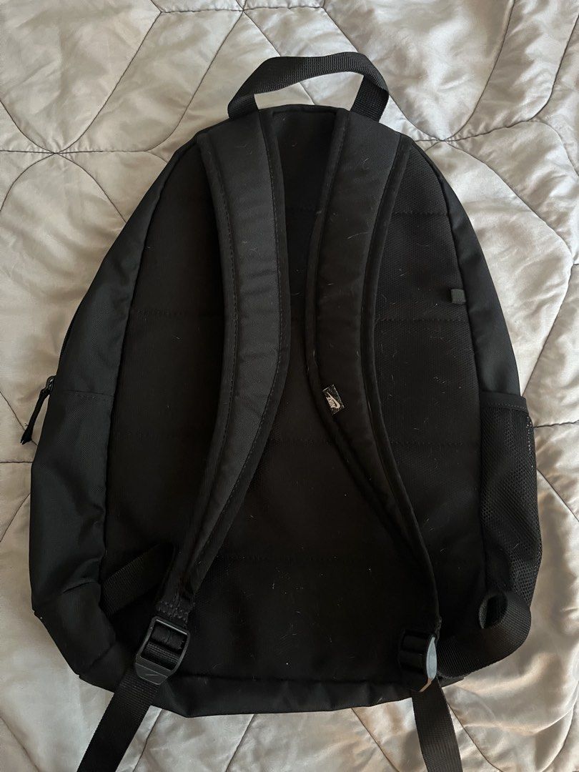 Nike Black Backpack with Grunge Emo Skater Silver Studs (Category: Backpacks) located in Quezon City. Submitted by toasterpiee (Listing ID 1469244360, Image 3). Description: - Brand: Nike - Color: Black with a large white front logo - Edgy Details: Metal pyramid studs along the left zipper - Storage: Main zippered compartment & side mesh water bottle pocket - Comfort: Padded standard shoulder straps & sturdy top handle - Flaws: Minor dirt marks o
