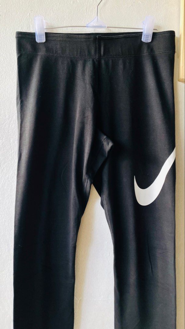 Nike Black Leggings (Category: Activewear) located in Caloocan City. Submitted by lovemyclothes21 (Listing ID 1469269742, Image 3). Description: - Brand: Nike - Color: Classic Black with White Swoosh on hip and lower leg - Size: 28 waist / 35 length - Material: Cotton and stretch blend (Made in Sri Lanka) - Condition: Great / Comfort-focused - Best for: Workouts, gym sessions, or daily casual wear - Features: Super comfortable, breathable, and ea