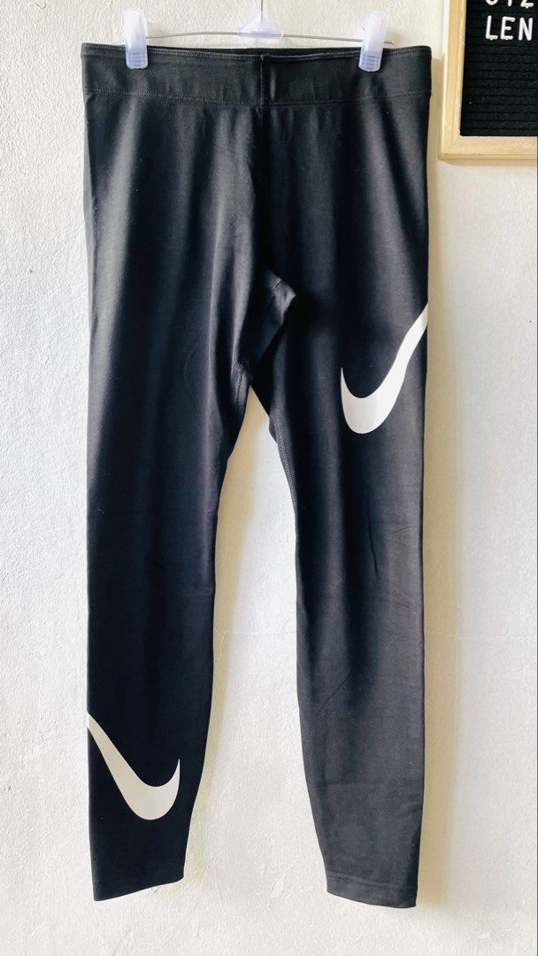 Nike Black Leggings (Category: Activewear) located in Caloocan City. Submitted by lovemyclothes21 (Listing ID 1469269742, Image 2). Description: - Brand: Nike - Color: Classic Black with White Swoosh on hip and lower leg - Size: 28 waist / 35 length - Material: Cotton and stretch blend (Made in Sri Lanka) - Condition: Great / Comfort-focused - Best for: Workouts, gym sessions, or daily casual wear - Features: Super comfortable, breathable, and ea