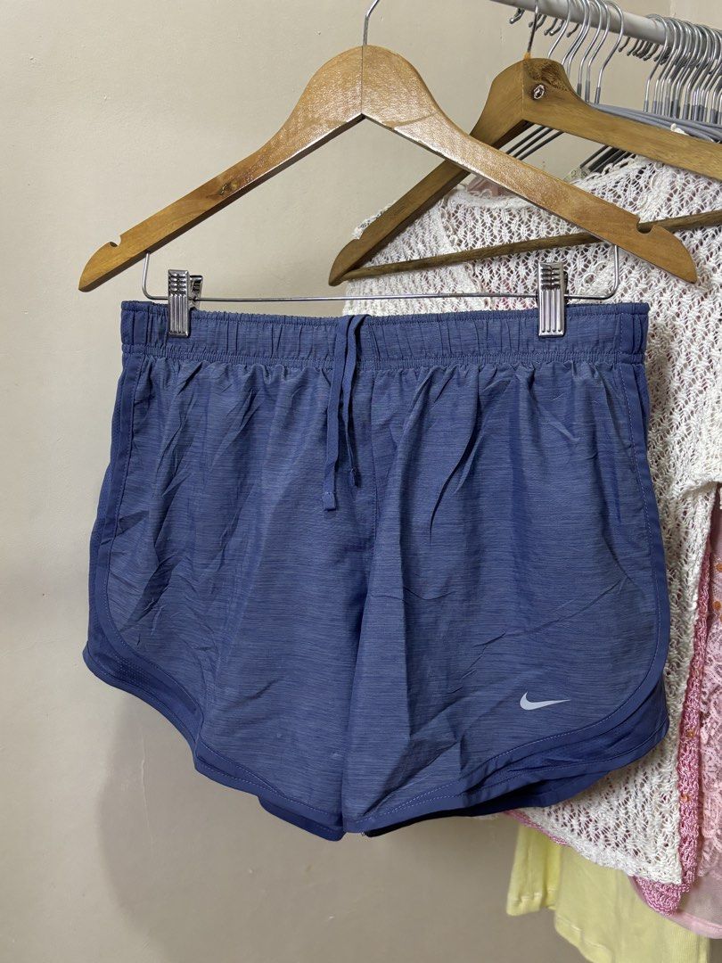 Nike Blue Athletic Running Shorts (Category: Shorts) located in Ajuy. Submitted by galitsabarat (Listing ID 1469337624, Image 1). Description: GOOD AS NEW CONDITION NO ISSUES - Brand: Nike - Color: Blue with a stylish heathered finish - Material: Lightweight and breathable - Waistband: Elastic with adjustable drawstring - Design: Curved hem with side slits for maximum mobility - Comfort: Built-in inner lining for extra coverage - Details: Small w