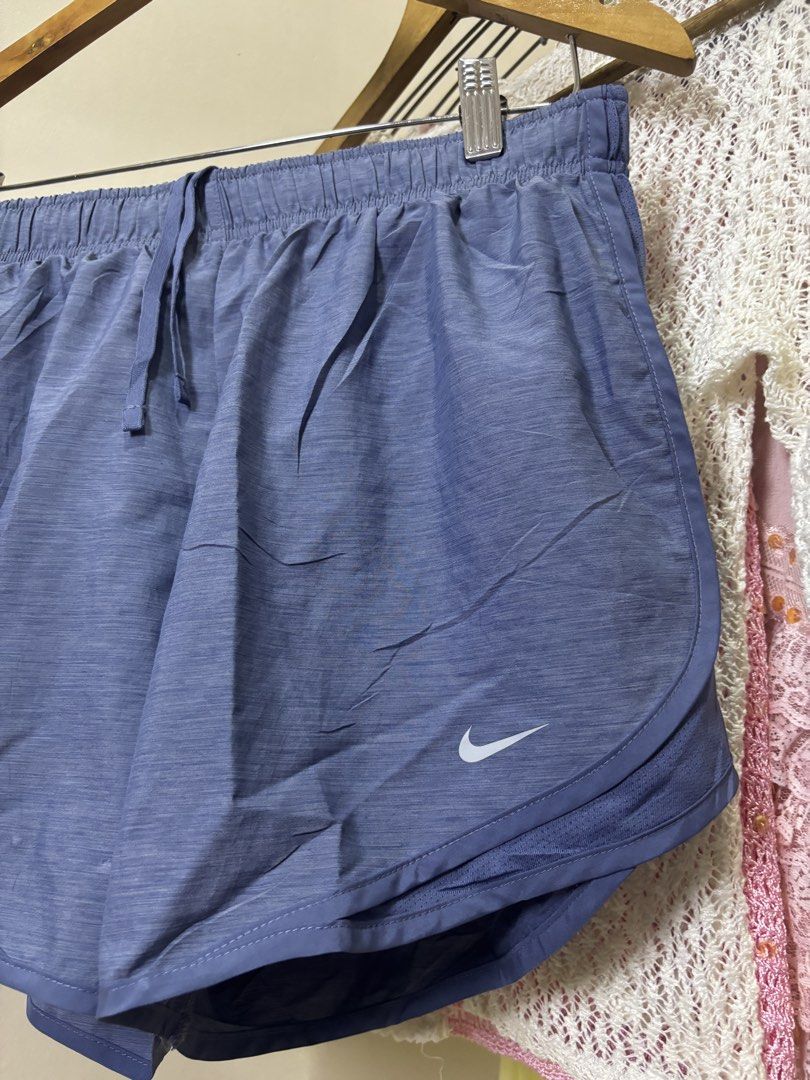 Nike Blue Athletic Running Shorts (Category: Shorts) located in Ajuy. Submitted by galitsabarat (Listing ID 1469337624, Image 3). Description: GOOD AS NEW CONDITION NO ISSUES - Brand: Nike - Color: Blue with a stylish heathered finish - Material: Lightweight and breathable - Waistband: Elastic with adjustable drawstring - Design: Curved hem with side slits for maximum mobility - Comfort: Built-in inner lining for extra coverage - Details: Small w