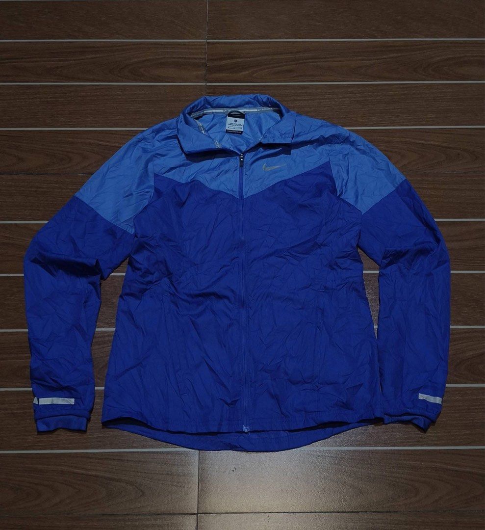 Nike Blue Windbreaker Running Jacket (Category: Coats, Jackets and Outerwear) located in Manila. Submitted by wanluis (Listing ID 1469217702, Image 1). Description: - Brand: Nike - Color: Two-tone blue - Closure: Full zip with high collar - Material: Lightweight, packable windbreaker - Safety: Reflective tape on cuffs for low-light visibility - Fit: Standard Nike fit.