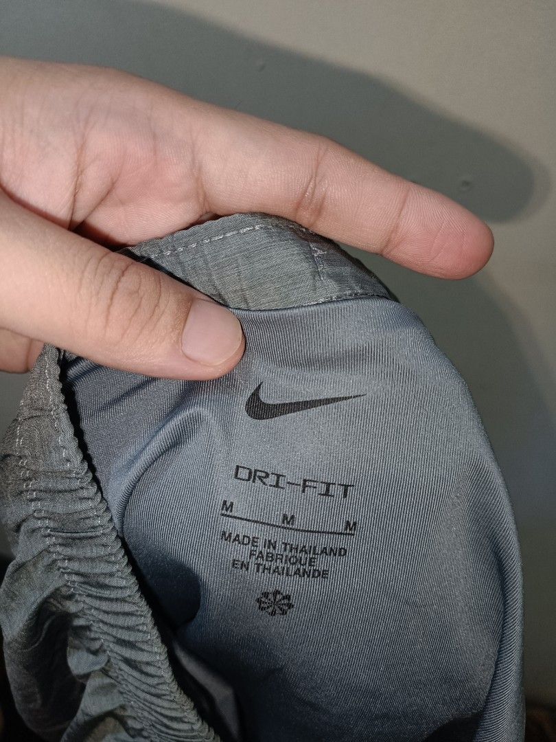 Nike Dri Fit Short (Category: Shorts) located in Makati City. Submitted by ivsseyow03 (Listing ID 1469278951, Image 3). Description: Grey Nike shorts with Dri-FIT technology to keep you dry during workouts. Size M, made in Thailand. Elastic waistband with drawstring for a secure fit. Breathable mesh side panels for extra airflow. Iconic white Nike swoosh printed near the hem. Great for running, gym sessions, or casual wear..