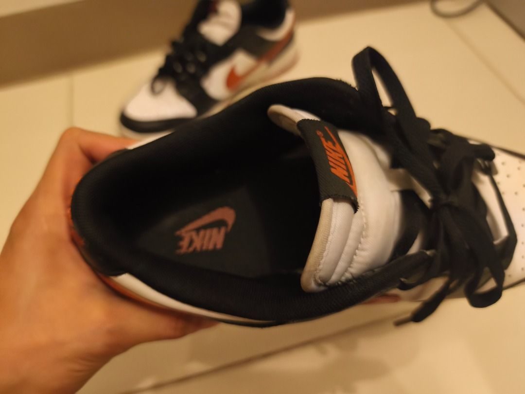 Nike Dunk Low (Category: Sneakers) located in Pasay City. Submitted by goldentree.711b44 (Listing ID 1469351010, Image 2). Description: - Brand: Nike Dunk Low - Colorway: Black, White, and Orange - Material: Premium leather upper with textured swoosh - Condition: Minor dirt marks on midsoles and soles from normal wear; tread still has plenty of grip left - Features: Classic low-top design and standard lace-up closure - Perfect as an everyday rota