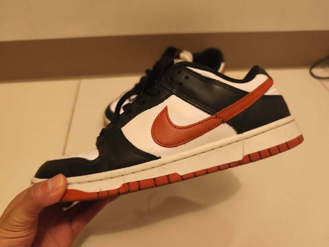 Nike Dunk Low (Category: Sneakers) located in Pasay City. Submitted by goldentree.711b44 (Listing ID 1469351010, Image 1). Description: - Brand: Nike Dunk Low - Colorway: Black, White, and Orange - Material: Premium leather upper with textured swoosh - Condition: Minor dirt marks on midsoles and soles from normal wear; tread still has plenty of grip left - Features: Classic low-top design and standard lace-up closure - Perfect as an everyday rota