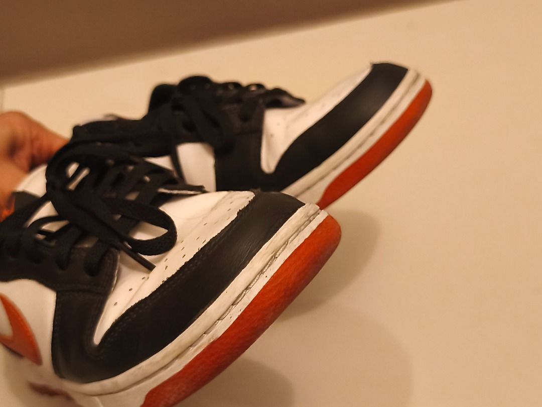 Nike Dunk Low (Category: Sneakers) located in Pasay City. Submitted by goldentree.711b44 (Listing ID 1469351010, Image 3). Description: - Brand: Nike Dunk Low - Colorway: Black, White, and Orange - Material: Premium leather upper with textured swoosh - Condition: Minor dirt marks on midsoles and soles from normal wear; tread still has plenty of grip left - Features: Classic low-top design and standard lace-up closure - Perfect as an everyday rota