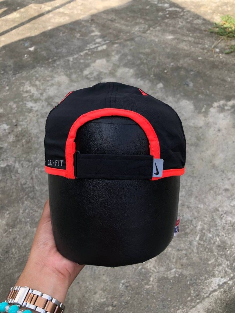 Nike Featherlight Dri-FIT Black and Red Cap (Category: Caps & Hats) located in Manila. Submitted by jowiegarci63146 (Listing ID 1469311504, Image 3). Description: - Authentic Nike Featherlight Dri-FIT cap in sleek black with bright red trim - Iconic embroidered red Swoosh on the front - Lightweight, breathable material ideal for running and gym workouts - Adjustable velcro strap in the back with Nike logo tag for a custom fit - Dri-FIT technology