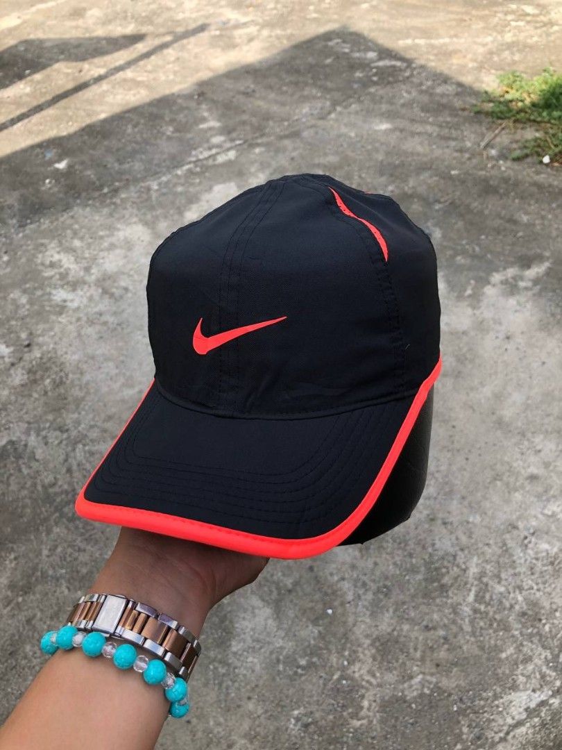 Nike Featherlight Dri-FIT Black and Red Cap (Category: Caps & Hats) located in Manila. Submitted by jowiegarci63146 (Listing ID 1469311504, Image 2). Description: - Authentic Nike Featherlight Dri-FIT cap in sleek black with bright red trim - Iconic embroidered red Swoosh on the front - Lightweight, breathable material ideal for running and gym workouts - Adjustable velcro strap in the back with Nike logo tag for a custom fit - Dri-FIT technology