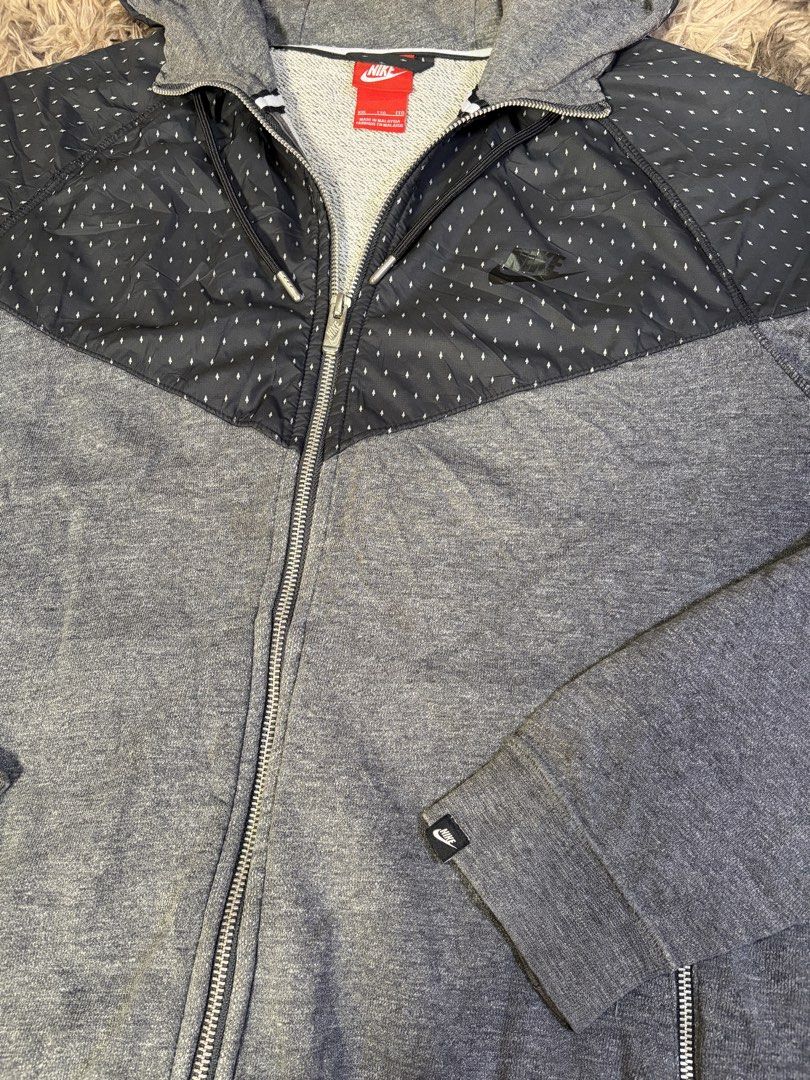 Nike Gray Patterned Zip-Up Hoodie XXL (Category: Hoodies) located in Manila. Submitted by _valuevault777 (Listing ID 1469178690, Image 3). Description: - Brand: Nike - Color: Dark gray and heather gray - Size: XXL (Standard Fit) - Origin: Made in Malaysia - Design: Patterned overlay on upper chest and hood - Features: Adjustable drawstrings, two secure front zip pockets, soft interior lining, ribbed cuffs and hem.