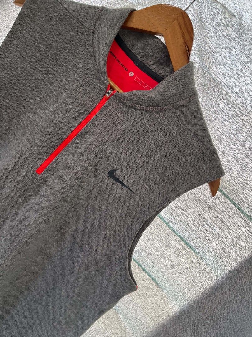 NIKE GRAY GOLF COATS (Category: Sleeveless) located in Caloocan City. Submitted by oldmoneyoutfit123 (Listing ID 1469310827, Image 3). Description: - Brand: Nike - Size: L - Color: Gray with red interior lining and red half-zip - Design: Sleeveless, mock neck, embroidered black Nike Swoosh on left chest - Material: Stretchy, comfortable ribbed knit - Condition: Excellent pre-loved condition - Perfect for activewear or casual layering.