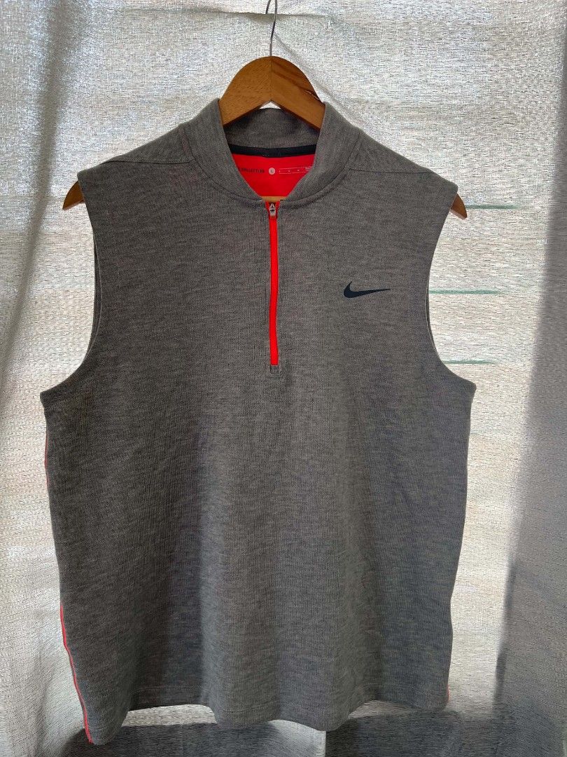 NIKE GRAY GOLF COATS (Category: Sleeveless) located in Caloocan City. Submitted by oldmoneyoutfit123 (Listing ID 1469310827, Image 2). Description: - Brand: Nike - Size: L - Color: Gray with red interior lining and red half-zip - Design: Sleeveless, mock neck, embroidered black Nike Swoosh on left chest - Material: Stretchy, comfortable ribbed knit - Condition: Excellent pre-loved condition - Perfect for activewear or casual layering.