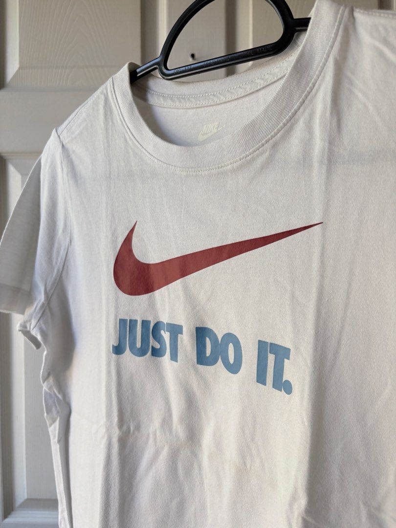 Nike Just Do It T-Shirt (Category: Babies & Kids Fashion) located in Liloan. Submitted by mrs.jboiser (Listing ID 1469226041, Image 3). Description: - Brand: Nike - Color: White with maroon swoosh and light blue 'JUST DO IT' text - Fit: Standard fit, short sleeves, crew neck - Style: Casual everyday tee - Shipping & Meet-ups: DM for details / Fast shipping available.