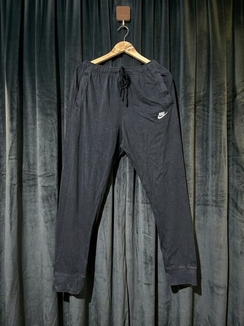 Nike Men's Jogger Sweatpants Grey and Black Bundle (Category: Joggers) located in Manila. Submitted by realjude (Listing ID 1469344294, Image 2). Description: - Bundle includes: 2 pairs of Nike fleece joggers (Light Grey & Dark Grey/Black) - Material: Soft and comfortable cotton blend - Fit: Standard fit with elastic waistband and adjustable drawstring - Design: Classic white embroidered Nike logo on the left thigh - Features: Convenient side poc