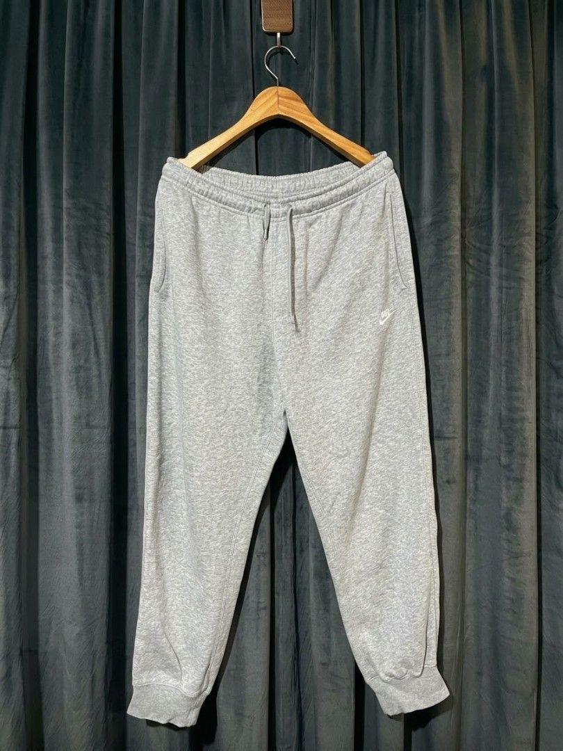 Nike Men's Jogger Sweatpants Grey and Black Bundle (Category: Joggers) located in Manila. Submitted by realjude (Listing ID 1469344294, Image 1). Description: - Bundle includes: 2 pairs of Nike fleece joggers (Light Grey & Dark Grey/Black) - Material: Soft and comfortable cotton blend - Fit: Standard fit with elastic waistband and adjustable drawstring - Design: Classic white embroidered Nike logo on the left thigh - Features: Convenient side poc