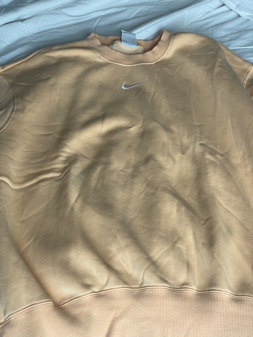 Nike Peach Crewneck Sweatshirt Size S (Category: Coats, Jackets and Outerwear) located in Angono. Submitted by marketplacesellerph610 (Listing ID 1469164485, Image 1). Description: Authentic - Brand/Model: Nike crewneck sweatshirt - Color: Peach - Size: Small (Made in Jordan) - Details: Embroidered mini swoosh, soft fleece lining, ribbed collar, cuffs, and hem - Condition: Great basic layering piece, but has a small hole on the fabric as pictured