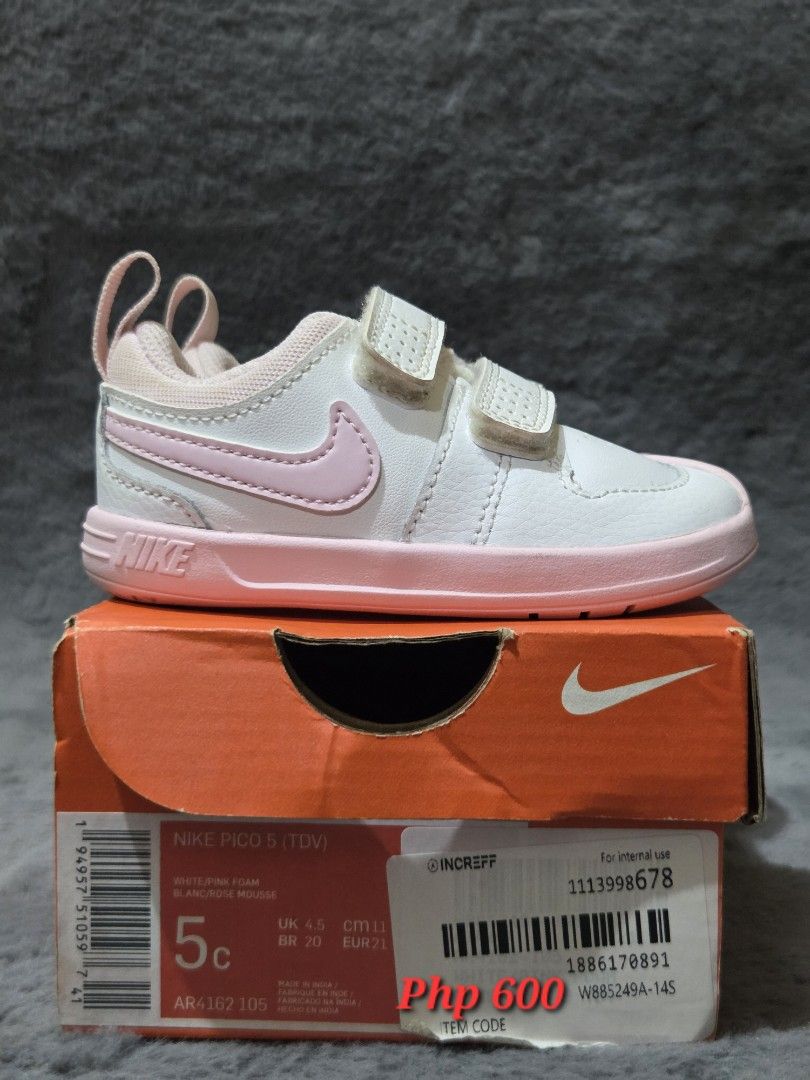 Nike Pico 5 TDV (Category: Babies & Kids Fashion) located in Bulacan. Submitted by gtrvddg (Listing ID 1469230262, Image 1). Description: - Brand: Nike Pico 5 Toddler Shoes - Color: White and Pink Foam - Size: US 5C / UK 4.5 / EUR 21 - Closure: Double hook-and-loop strap for easy on and off - Condition: Clean upper and sole - Packaging: Original orange box included.