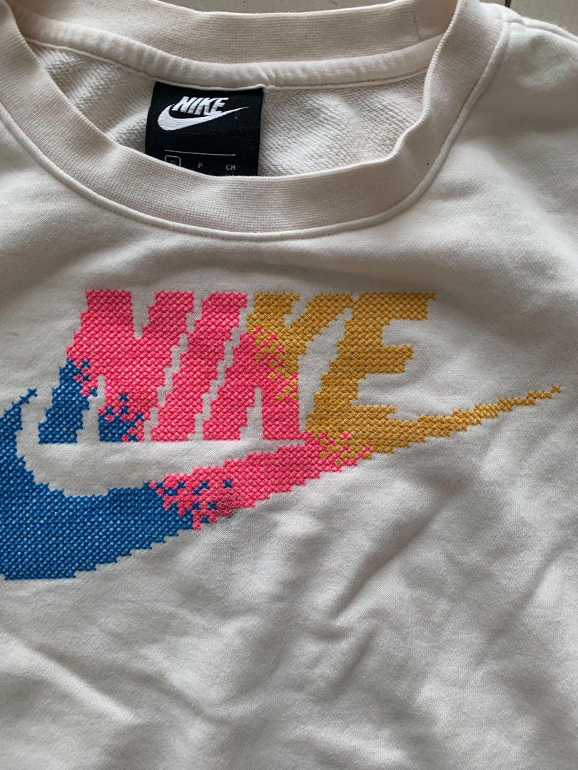 Nike Pixelated Gradient Logo White Sweatshirt Size S (Category: Coats, Jackets and Outerwear) located in Manila. Submitted by llamanzaresdave11 (Listing ID 1469188010, Image 3). Description: Size - Small Dimensions: Width - 21 Length - 17 Color Rate: 9.5/10 Excellent condition Issue: Flawed; has noticeable yellowish stains on the front near the hem and stains on the sleeve.