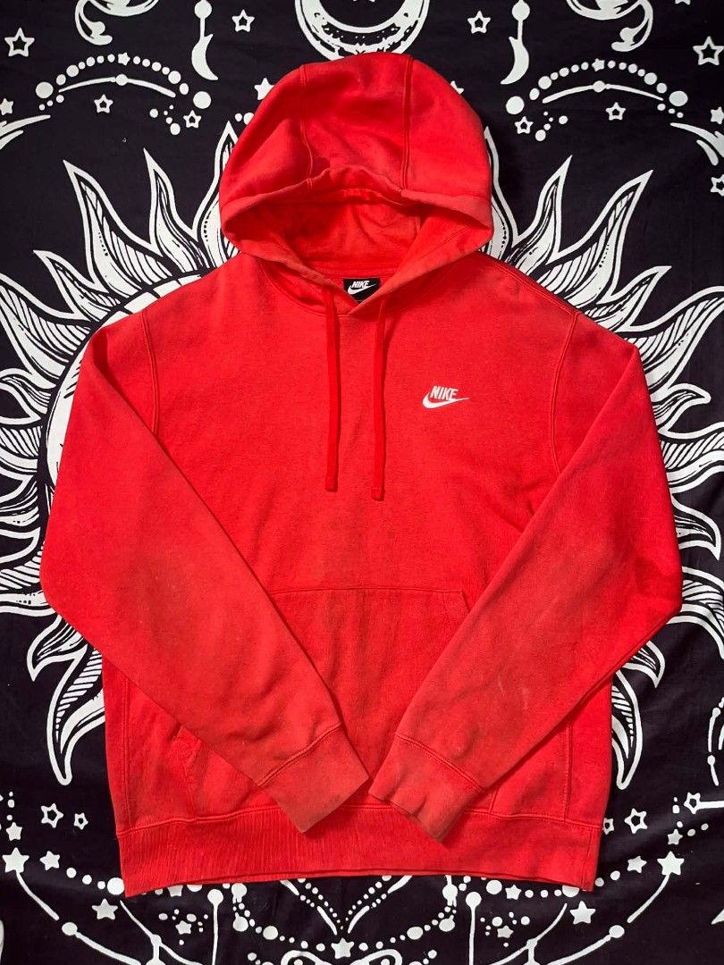 Nike Red Hoodie (Category: Hoodies) located in Manila. Submitted by joshua_varona11 (Listing ID 1469203418, Image 2). Description: - Brand/Item: Nike Hoodie - Color: Bright red with classic white embroidered logo - Size: Medium (M) - Features: Thick fleece lining, front kangaroo pocket, adjustable drawstring hood - Condition: Pre-loved with visible fading and wear marks on the sleeves and collar.