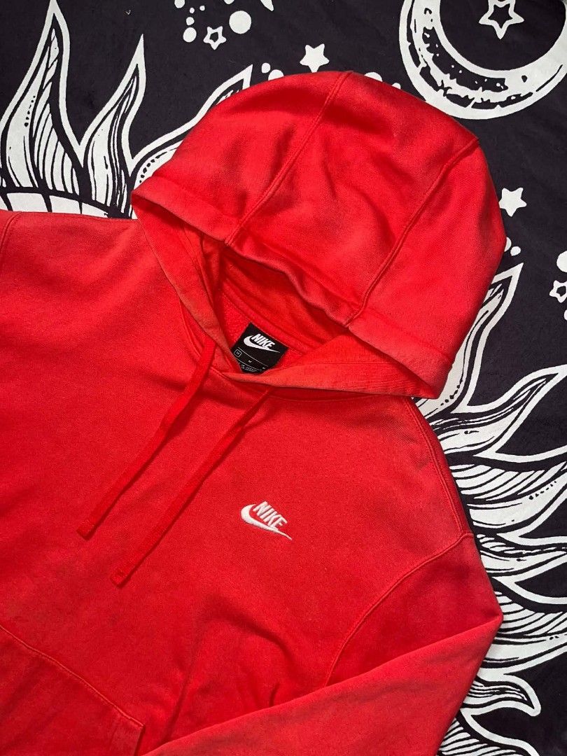 Nike Red Hoodie (Category: Hoodies) located in Manila. Submitted by joshua_varona11 (Listing ID 1469203418, Image 3). Description: - Brand/Item: Nike Hoodie - Color: Bright red with classic white embroidered logo - Size: Medium (M) - Features: Thick fleece lining, front kangaroo pocket, adjustable drawstring hood - Condition: Pre-loved with visible fading and wear marks on the sleeves and collar.
