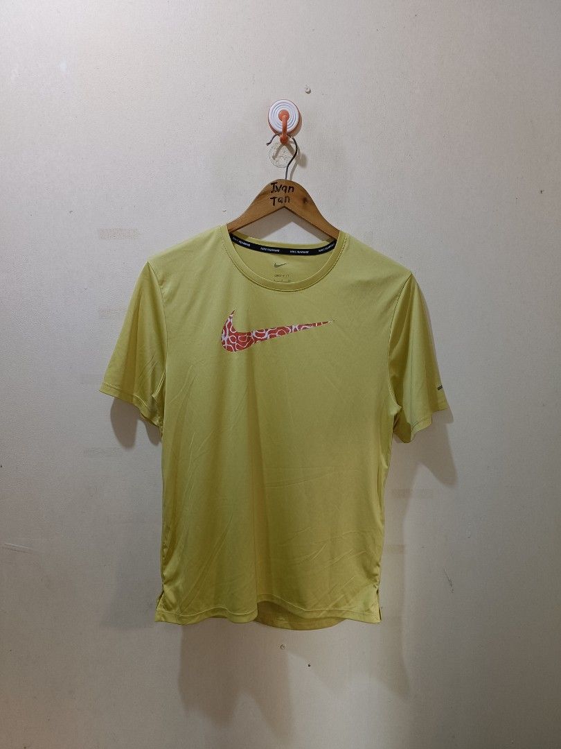 Nike Running Shirt (Category: Activewear) located in Makati City. Submitted by ivsseyow03 (Listing ID 1469278930, Image 1). Description: Yellow-green Nike running t-shirt in size small. Features a patterned red and white swoosh logo across the chest. Nike Running text taping along the inner collar. Dri-fit material keeps you cool and dry. Lightweight fabric with short sleeves. Style code DM4816-304 printed on the inner tag..