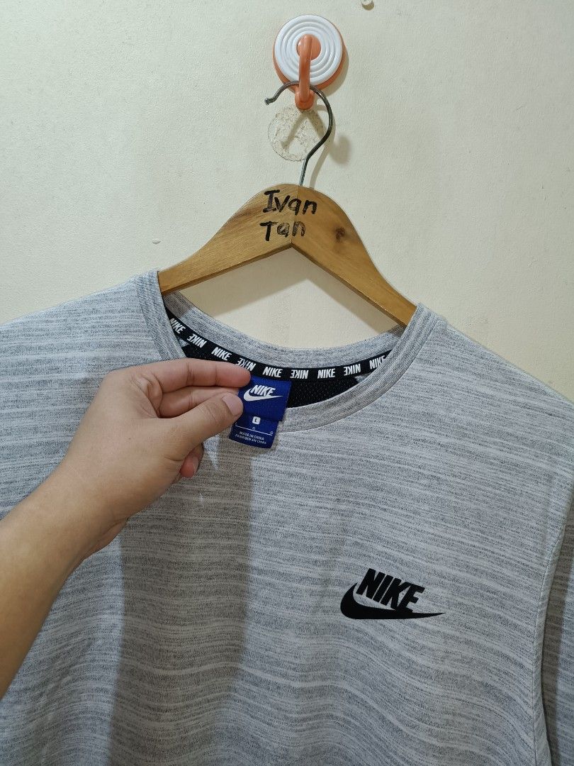 Nike Shirt (Category: Tshirts & Polo Shirts ) located in Makati City. Submitted by ivsseyow03 (Listing ID 1469278937, Image 2). Description: Gray heathered crew neck t-shirt from Nike. Black Nike logo printed on the left chest. Interior collar features repeating Nike text taping detail. Size large tag attached at the inner blue neck label. Side slits at the bottom hem for extra mobility. Cotton blend fabric, soft and comfortable. Standard fit..