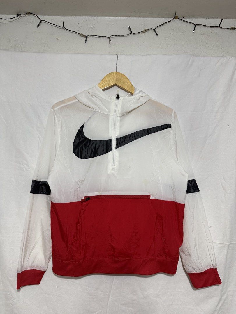 Nike Windbreaker Jacket White Red Black Size XL (Category: Coats, Jackets and Outerwear) located in Quezon City. Submitted by dapanaaaay (Listing ID 1469347994, Image 1). Description: - Brand: Nike (Style Code: DJ5727-100) - Size: XL - Color: White, Red, and Black - Design: Iconic Big Swoosh logo across the chest - Features: Half-zip neck with hood, front kangaroo pocket with zippered section, ribbed cuffs and hem - Material: Lightweight fabric w