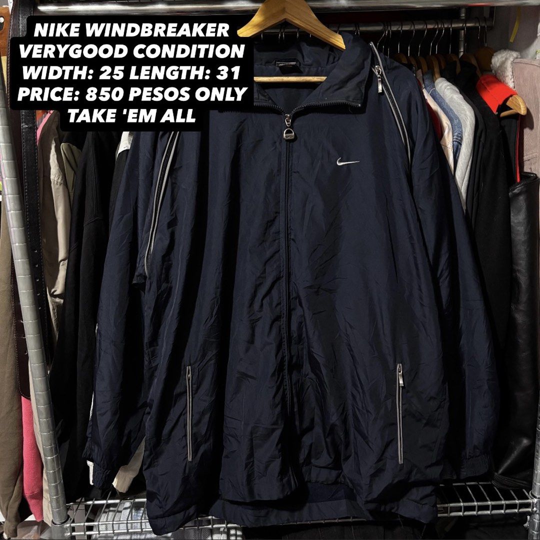 Nike Windbreaker Navy Blue (Category: Coats, Jackets and Outerwear) located in Caloocan City. Submitted by bonsatocha43876 (Listing ID 1469321077, Image 1). Description: - Brand: Nike - Color: Navy blue - Material: 100% nylon (Made in Indonesia) - Size/Fit: Width 25" x Length 31" - Design: Full zip front with custom branded zipper pull, iconic Nike swoosh embroidery on the chest, and stylish piping along the shoulders and sleeves - Storage: Dual 
