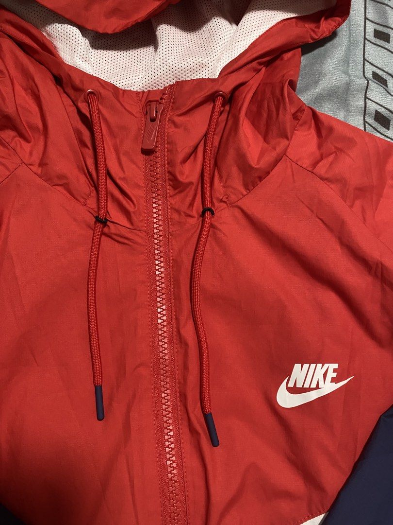 Nike Windrunner Hooded Jacket Red White Blue XL (Category: Coats, Jackets and Outerwear) located in Taguig. Submitted by maaarrrrrcky (Listing ID 1469263791, Image 3). Description: - Brand: Nike - Style: Windrunner Jacket (Colorblock: Red, White, Blue) - Size: XL on tag but not too big - Features: Full zip closure, matching red drawstrings, white mesh-lined hood, and two zippered side pockets - Details: Iconic chest chevron with classic printed w