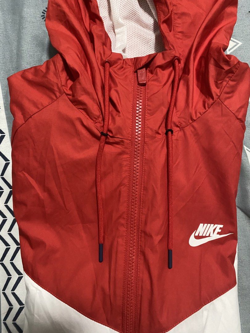 Nike Windrunner Hooded Jacket Red White Blue XL (Category: Coats, Jackets and Outerwear) located in Taguig. Submitted by maaarrrrrcky (Listing ID 1469263791, Image 2). Description: - Brand: Nike - Style: Windrunner Jacket (Colorblock: Red, White, Blue) - Size: XL on tag but not too big - Features: Full zip closure, matching red drawstrings, white mesh-lined hood, and two zippered side pockets - Details: Iconic chest chevron with classic printed w