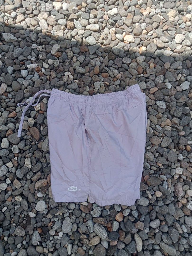Nike woven size medium (Category: Shorts) located in Bais. Submitted by gelothrifts (Listing ID 1469186110, Image 1). Description: - Brand: Nike - Color: Lavender - Size: Medium (Tag on inside) - Features: Drawstring waist with matching purple strings, mesh lining inside - Details: White embroidered Nike logo on bottom right leg - Product Code: DR5678-576 - Origin: Made in Vietnam - Condition: Good, versatile for workouts or daily casual wear.