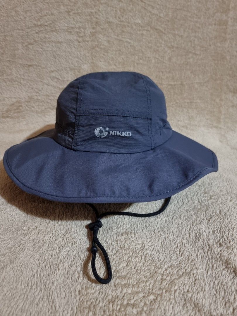 NIKKO Outdoor Bucket Hat (Category: Hats & Beanies) located in Imus. Submitted by aim_for_less (Listing ID 1469306316, Image 1). Description: NIKKO Outdoor Bucket Hat - Brand: NIKKO - SIZE: 60CM - Color: Dark grey - Wide brim for maximum sun protection - Adjustable black chin cord with toggle for a secure fit - Lightweight material with breathable inner mesh lining - Features the brand logo printed on the side - Ideal for hiking, fishing, gardeni