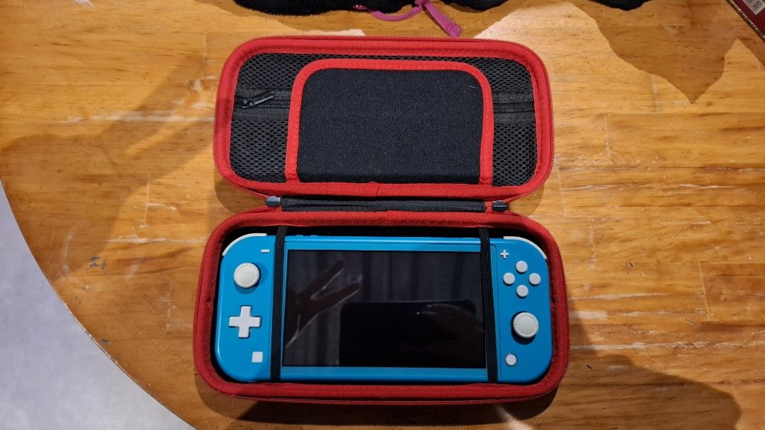 Nintendo Switch Lite Turquoise with Case and Charger (Category: Nintendo) located in Quezon City. Submitted by cyulaters (Listing ID 1469312242, Image 1). Description: - Item: Nintendo Switch Lite Handheld Console - Color: Turquoise - Included: Original power adapter and black Dobe carrying case with red trim - Condition: Has some screen burn in its corners 😀 the Screen, joysticks, and buttons are clean and fully functional though; normal wear o