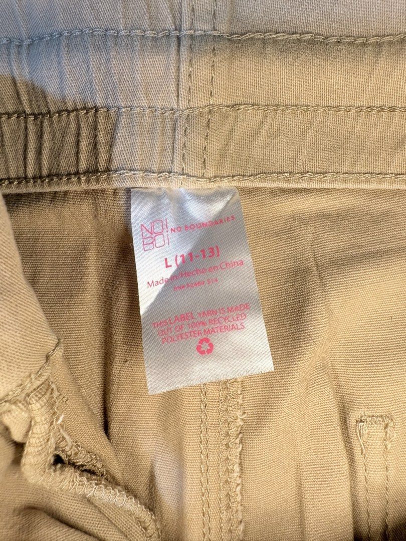 No Boundaries Beige Cargo Pants Size L 11-13 (Category: Jeans) located in Manila. Submitted by thriftwithgem (Listing ID 1469252044, Image 2). Description: - Brand: No Boundaries - Size: L (fits 11-13) - Color: Tan / Neutral Khaki - Material: Recycled polyester - Waist: Drawstring with zip fly and button closure - USED ONCE.