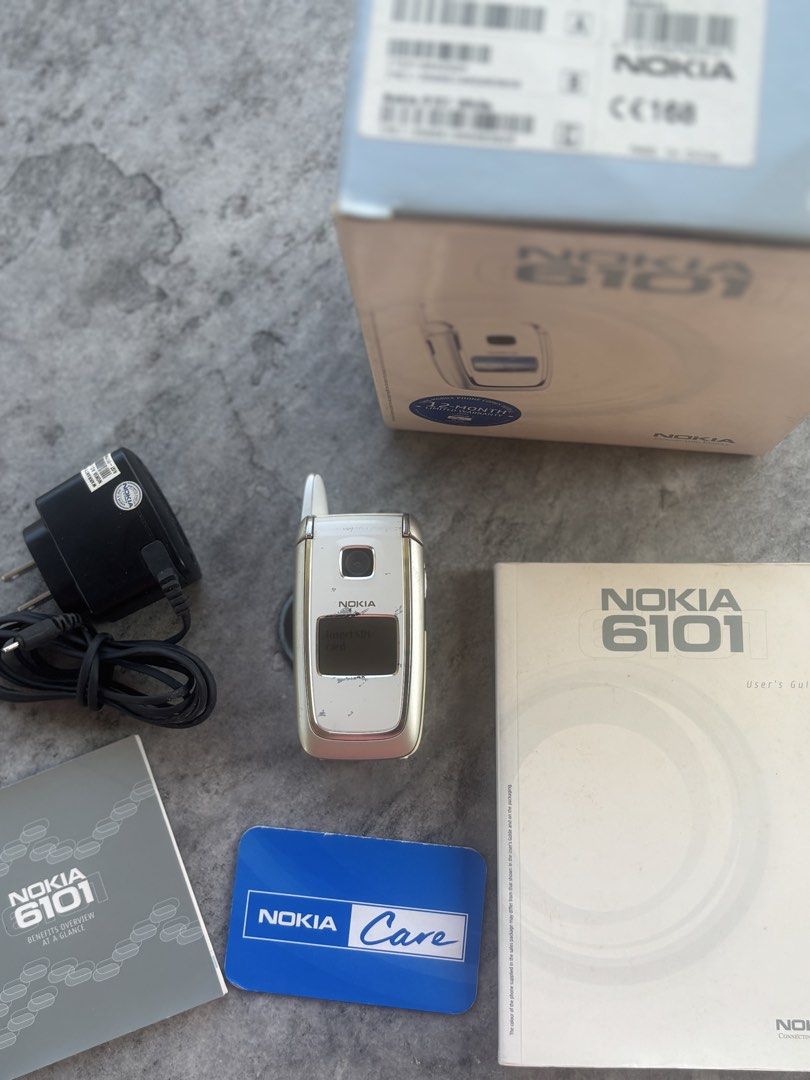 Nokia 6101 (Category: Early Generation Mobile Phones) located in Iloilo. Submitted by TheKinfolkGarage (Listing ID 1469169126, Image 1). Description: - Brand/Model: Nokia 6101 flip phone - Includes original retail box, wall charger, user manual, and Nokia Care card - Classic clamshell design with dual screens - Ideal collector's item or reliable backup phone - Shipping Fee: 180 pesos via J&T / LBC Express.