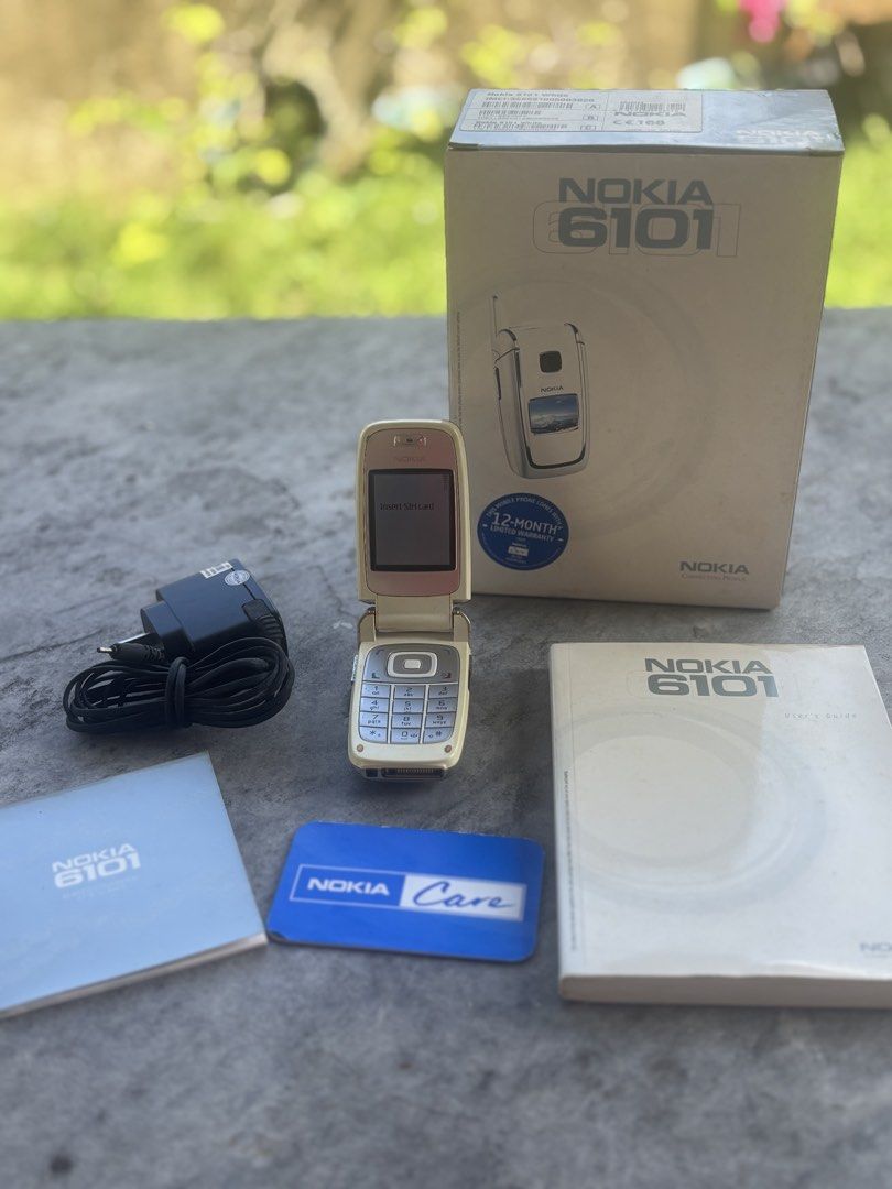 Nokia 6101 (Category: Early Generation Mobile Phones) located in Iloilo. Submitted by TheKinfolkGarage (Listing ID 1469169126, Image 2). Description: - Brand/Model: Nokia 6101 flip phone - Includes original retail box, wall charger, user manual, and Nokia Care card - Classic clamshell design with dual screens - Ideal collector's item or reliable backup phone - Shipping Fee: 180 pesos via J&T / LBC Express.