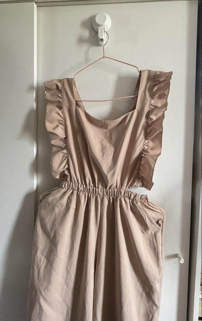 Nude Ruffle Jumpsuit with Bow Back (Category: Jumpsuits) located in Agdangan. Submitted by happyphoenix.d92869 (Listing ID 1469214375, Image 2). Description: - Color: Nude-pink - Style: Wide-leg jumpsuit with easy slip-on design - Details: Cute ruffle shoulder straps and sweet back tie-bow with open cutout - Comfort: Elastic waistband for all-day wear - Practicality: Features functional side pockets - Fabric: Lightweight and breathable, perfect f