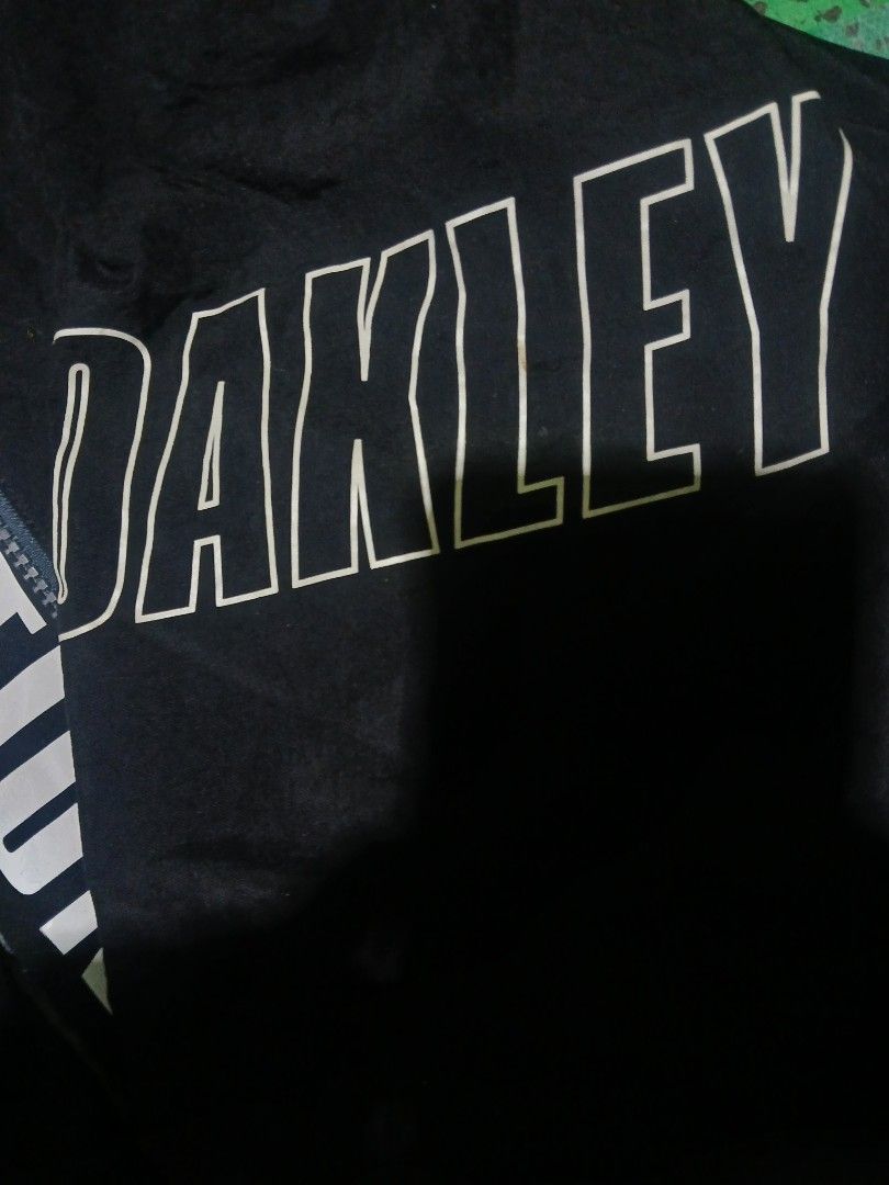 Oakley Evolution Never Ends Black Zip Jacket Size M (Category: Coats, Jackets and Outerwear) located in San Jose. Submitted by garments17 (Listing ID 1469318867, Image 2). Description: - Brand: Oakley - Color: Black - Size: US/EU Medium - Condition: Lightly worn, great overall condition - Design: Large white chest and sleeve branding with 'EVOLUTION NEVER ENDS' text along the front zipper placket - Interior: Comfortable waffle-textured inner lini