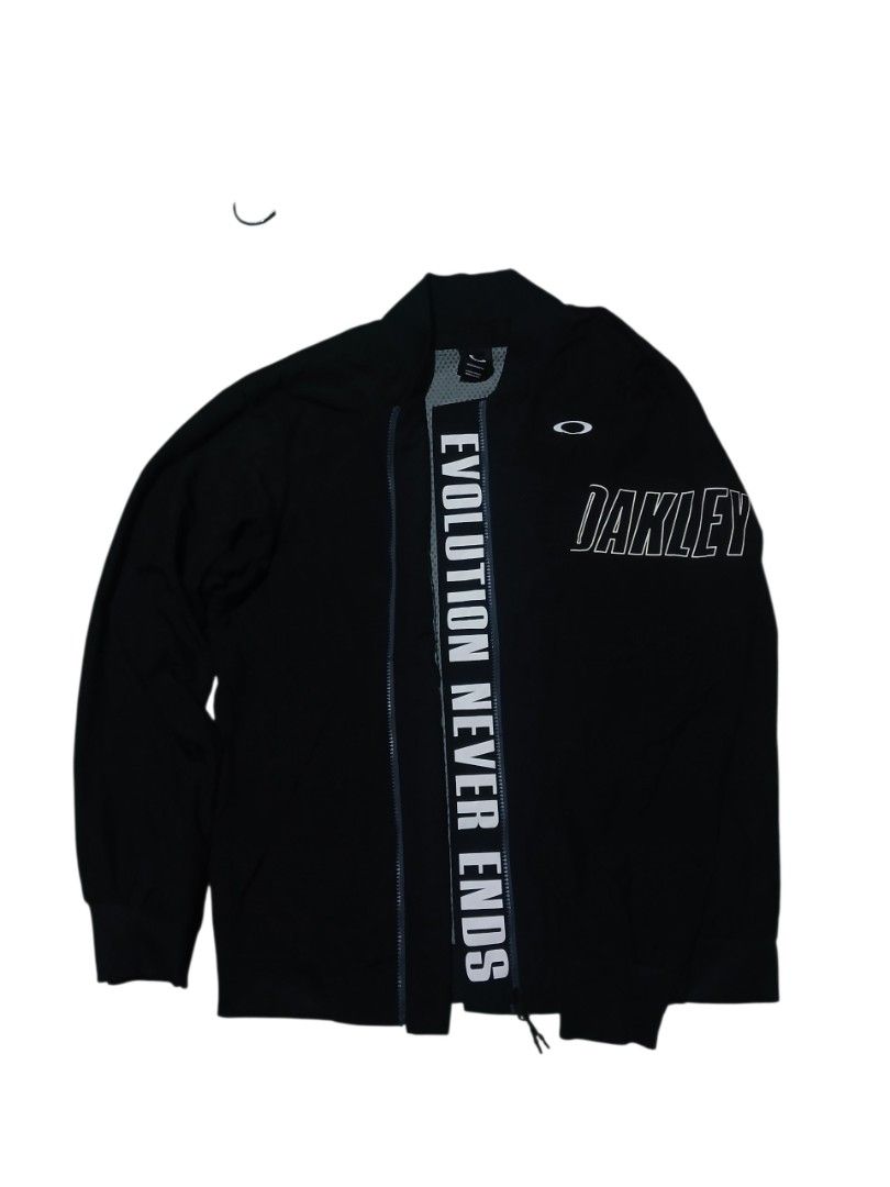 Oakley Evolution Never Ends Black Zip Jacket Size M (Category: Coats, Jackets and Outerwear) located in San Jose. Submitted by garments17 (Listing ID 1469318867, Image 1). Description: - Brand: Oakley - Color: Black - Size: US/EU Medium - Condition: Lightly worn, great overall condition - Design: Large white chest and sleeve branding with 'EVOLUTION NEVER ENDS' text along the front zipper placket - Interior: Comfortable waffle-textured inner lini