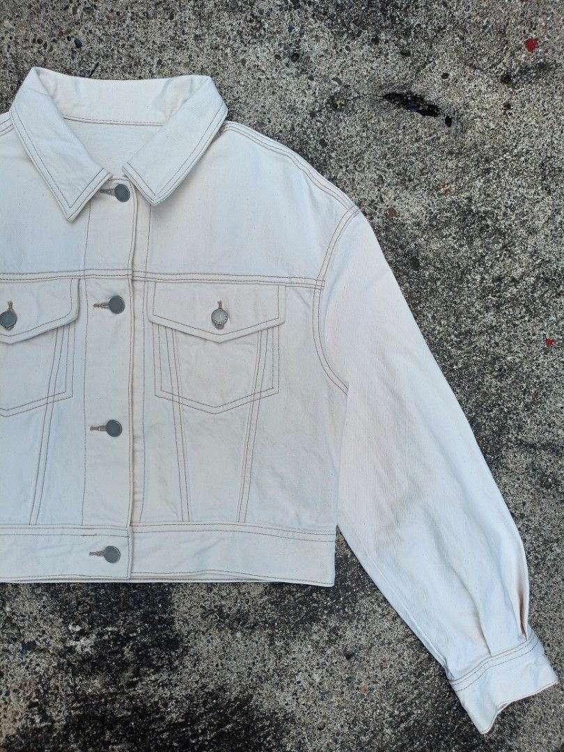 Off-white cropped denim jacket with contrast stitching (Category: Coats, Jackets and Outerwear) located in General Santos City (Dadiangas). Submitted by jay-fits (Listing ID 1469293211, Image 2). Description: GU Women's Denim Volume Sleeve Jacket GU Women's Denim Volume Sleeve Jacket Small on tag 19.5x18.5 Denim Color Rate 10/10, 🔥 Excellent Condition, No Issue Location Davao City Mine 590+Sf .