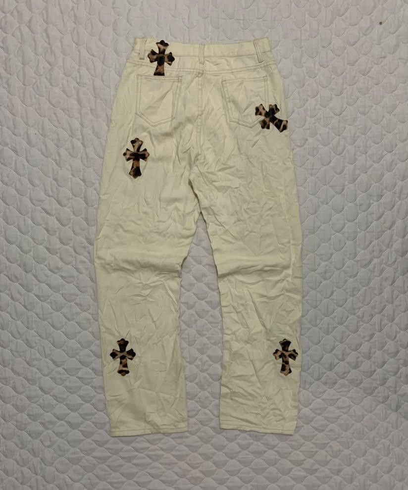 Off-White Jeans with Leopard Print Cross Patches (Category: Jeans) located in Manila. Submitted by vasteagle_347950 (Listing ID 1469294528, Image 2). Description: - Color: Off-white with brown leopard print cross patches - Fit: Straight leg with standard button and zip fly closure - Design: Five-pocket styling with belt loops - Details: Heavy patch detailing all over the front and back - Style: A unique and fun statement piece.