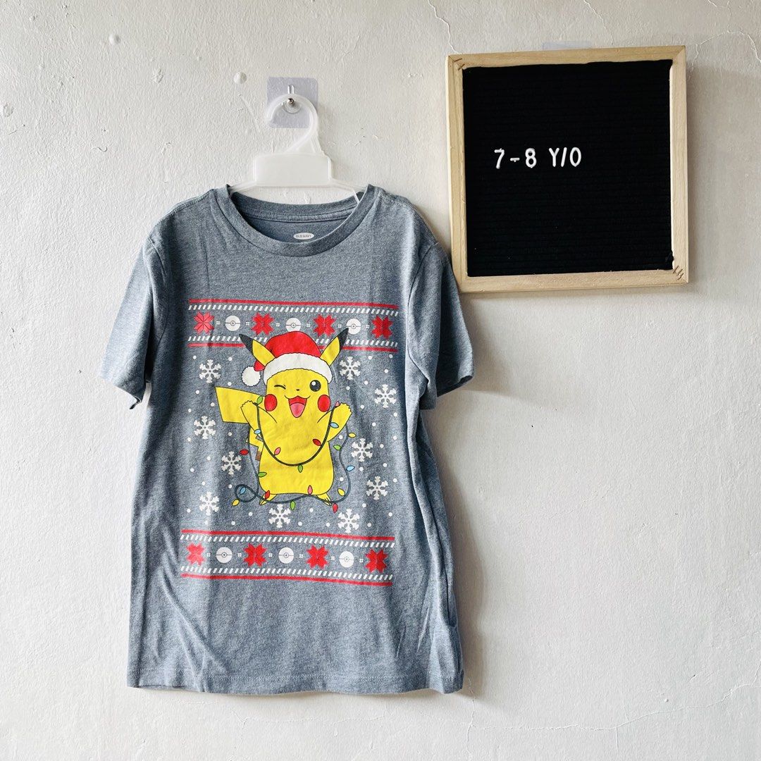 Old Navy Pokémon Pikachu Christmas top (Category: Babies & Kids Fashion) located in Caloocan City. Submitted by lovemyclothes21 (Listing ID 1469267494, Image 1). Description: - Brand: Old Navy - Design: Pikachu in a Santa hat with Christmas lights and snowflakes - Size: Medium (8) / Best for ages 7-8 years - Material: Soft and comfortable cotton blend - Style: Short sleeves, crew neck - Condition: Great holiday piece for young Pokémon fans.