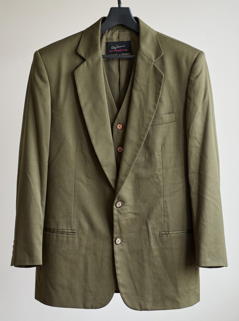 Oleg Cassini 2 button Jacket (Category: Coats, Jackets and Outerwear) located in Manila. Submitted by ditrik26 (Listing ID 1469340934, Image 1). Description: ​Brand: Oleg Cassini ​Item: 2-Button Blazer with Coordinating Vest ​Color: Deep Olive Green ​Condition: Pre-owned, excellent condition ​Key Features: Wide notch lapel, amber contrast buttons, jetted waist pockets, fully lined interior Dimensions: 22" x 34" Coat- Oleg Cassini Large Vest- Oleg