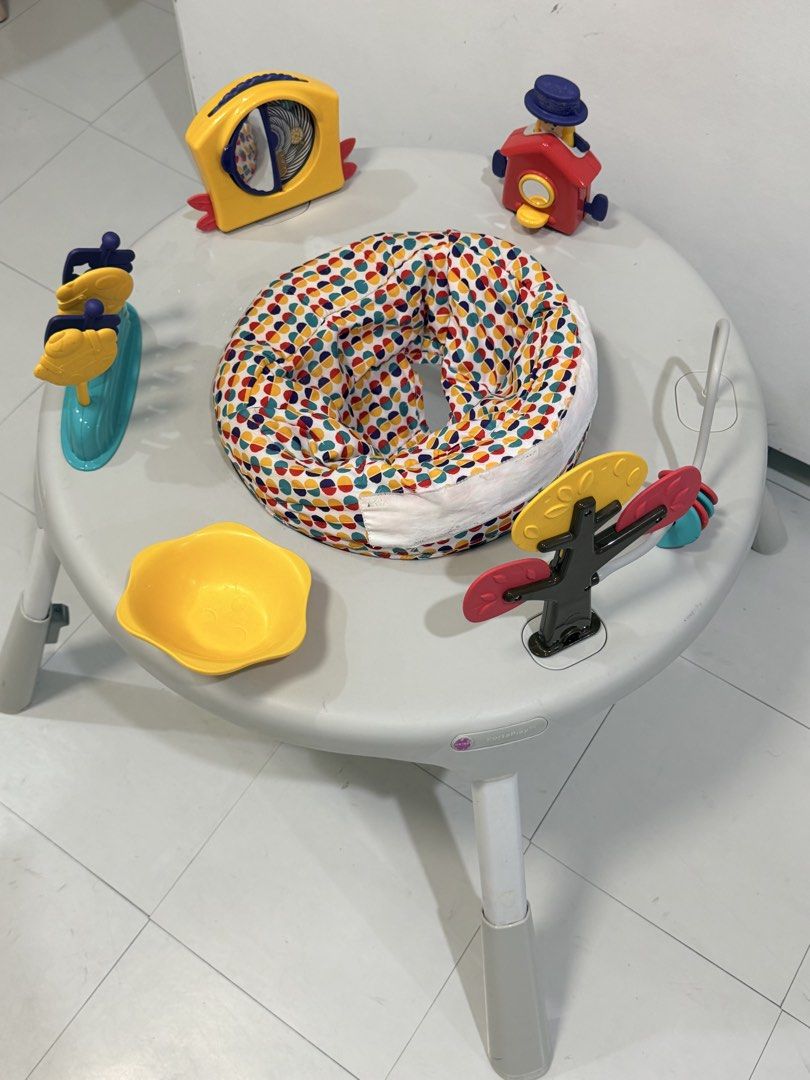 Oribel PortaPlay Convertible Activity Center (Category: Infant Playtime) located in Muntinlupa City. Submitted by monicanayve06 (Listing ID 1469250264, Image 2). Description: - Brand: Oribel PortaPlay activity center - Color: Grey with a colorful polka dot seat pad - Features: Converts from a seated activity center to a regular play table as baby grows - Includes: Interactive toys like a yellow house, spinning tree, mirror panel, and toys on stic
