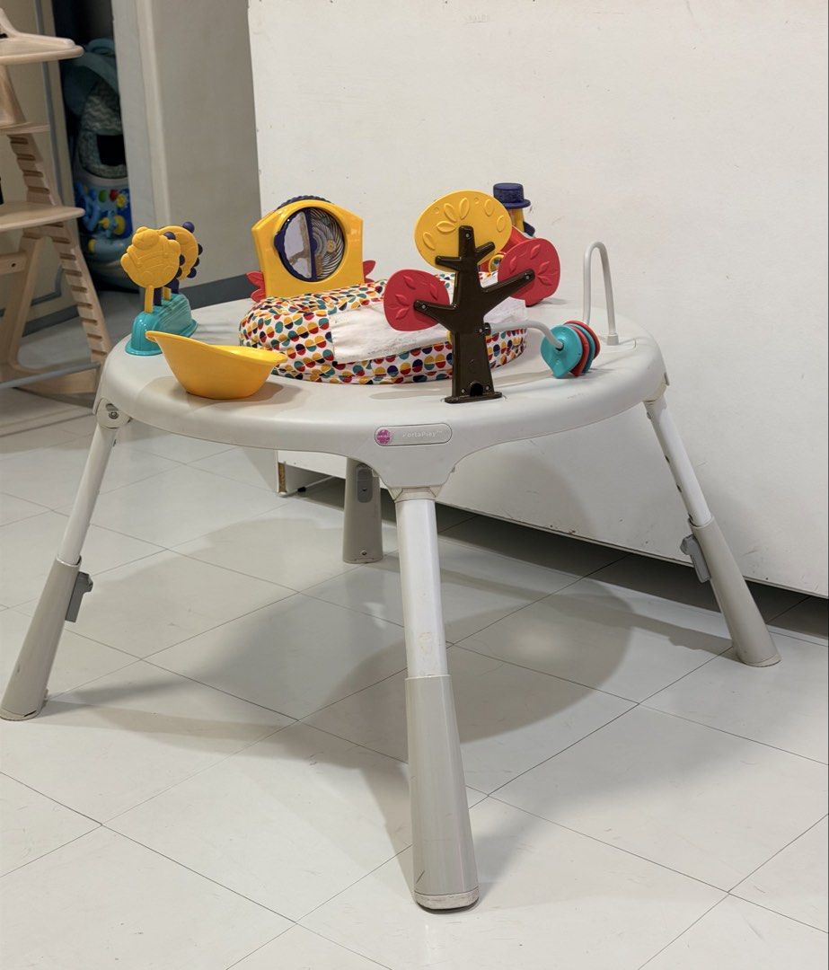 Oribel PortaPlay Convertible Activity Center (Category: Infant Playtime) located in Muntinlupa City. Submitted by monicanayve06 (Listing ID 1469250264, Image 1). Description: - Brand: Oribel PortaPlay activity center - Color: Grey with a colorful polka dot seat pad - Features: Converts from a seated activity center to a regular play table as baby grows - Includes: Interactive toys like a yellow house, spinning tree, mirror panel, and toys on stic
