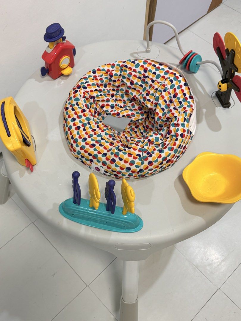 Oribel PortaPlay Convertible Activity Center (Category: Infant Playtime) located in Muntinlupa City. Submitted by monicanayve06 (Listing ID 1469250264, Image 3). Description: - Brand: Oribel PortaPlay activity center - Color: Grey with a colorful polka dot seat pad - Features: Converts from a seated activity center to a regular play table as baby grows - Includes: Interactive toys like a yellow house, spinning tree, mirror panel, and toys on stic
