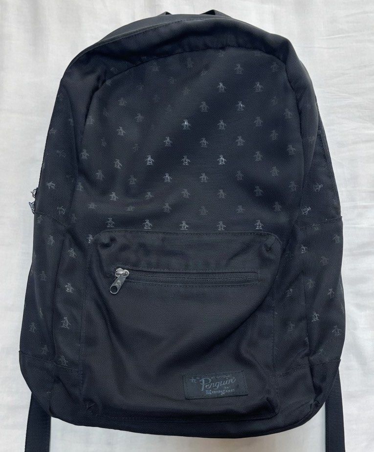 Original Penguin Munsingwear Black Penguin Print Backpack (Category: Backpacks) located in Quezon City. Submitted by aussomefinds (Listing ID 1458769695, Image 1). Description: - Stylish black backpack with a subtle all-over penguin print. - Front zip pocket for easy access to essentials. - Spacious main compartment for all your belongings. - Comfortable padded straps for easy carrying. - Authentic Original Penguin by Munsingwear branding. - Idea